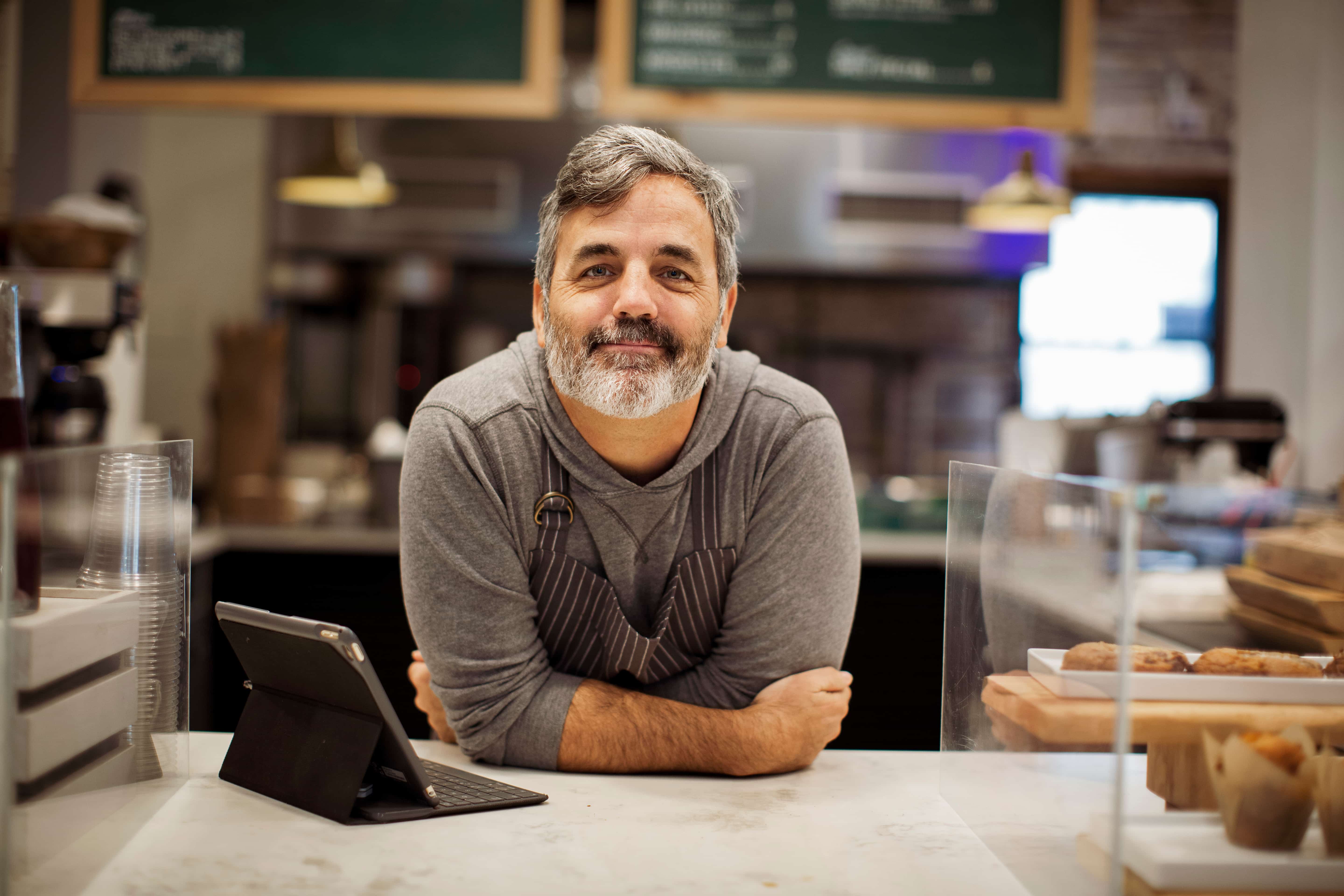 Man behind the counter in his bakery